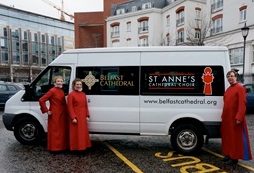 Hannah, Megan and Master of the Choristers David Stevens with the choir minibuses.