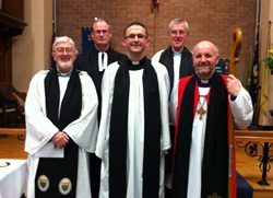 The Rev Stephen McElhinney, centre, with Bishop Alan Abernethy, right, and clergy who attended his institution.