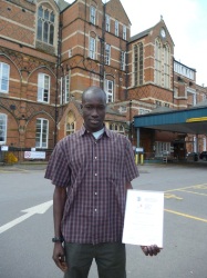 Top student Aligo from the Martha Clinic, Yei, with his diploma from the Liverpool School of Tropical Medicine.
