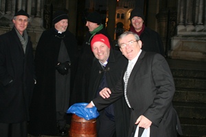 Canons Neil Cutcliffe and Ken McReynolds, Dean John Mann, former Archbishop Alan Harper and Bishop of Connor Alan Abernethy receive a donation from a Black Santa supporter.