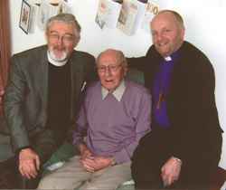 Helping David Johnston (centre) celebrate his 100th birthday are the Rev Canon John Budd and the Bishop of Connor.