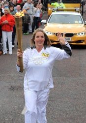 Dianne McMillan carries the Olympic torch in Carnlough.
