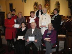 Rev David Ferguson and Mrs Moira Thom, left, with members of Ramoan and Culfeightrin MU.