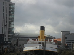 Old meets new. The restored Nomadic sits in dry dock, with the new Titanic apartments in the background.