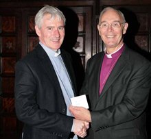 Canon Sam Wright, Lisburn Cathedral, is presented with the Parish Website first prize by the Archbishop of Armagh.