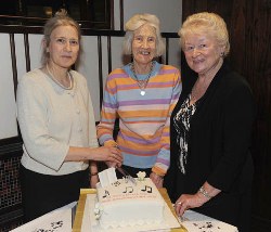 Meta Patterson (the longest serving choir member) and her daughter Rita Dodds, cut the 50th Anniversary cake.  Looking on is Jean Hazley, choir secretary.