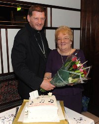 The rector, the Rev Canon James Carson, pictured presenting a bouquet of flowers to Mrs Isobel Gorman, Organist and Choirmistress.