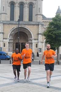 Marathon man Alastair Donaldson, right, with support runners Tenda Zengeni and Peter Burke.