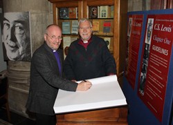 Bishops Alan and Harold prepare to write in the CS Lewis book in St Anne's Cathedral.