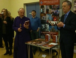 Bishop Alan browsing the new bilingual services book at the service in St George's, Belfast.