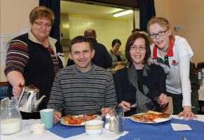 Gill Spence serving a low calorie fry up to the Rev Stephen McElhinney, his wife Cathy and their daughter Ruby at the Derryvolgie community event.