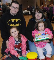 Jessica and Danielle with their dad Colin and grandmother Linda at a community event and fundraiser at Derryvolgie Parish Church.