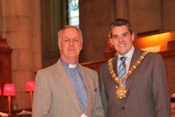 Lord Mayor Gavin Robinson presents a cheque to the Rev Colin Hall-Thompson, Mission to Seafarers.
