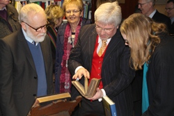 Paul Gilmore, who established the library at St Anne's, shows some of the collection to guests at the opening.