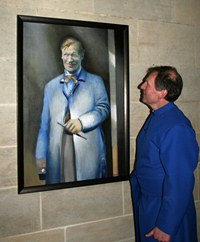 Dean Man looks at the painting of Morris Harding, now on display in St Anne's Cathedral.