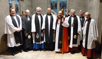Pictured at the Institution are, from left: The Rev David Lockhart, Rural Dean; the Rev William Taggart, Registrar; the Rev Canon Walter Lewis, Preacher; the Rev Brian Lacey, new rector of St Peter and St James; the Rt Rev Alan Abernethy, Bishop of Connor; the Rev Clifford Skillen, Bishop's Chaplain; the Very Rev John Bond, Dean of Connor; the Ven Stephen Forde, Archdeacon of Dalriada and the Rev Canon Stuart Lloyd, rector of Ballymena and Ballyclug.