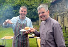 Archdeacon Stephen Forde, rector, is served a bite to eat during the Larne barbecue.