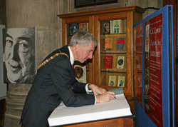 Belfast's Lord Mayor signs the CS Lewis book at St Anne's Cathedral.