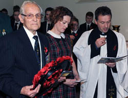 Christ Church parishioners Tommy Jess and his granddaughter Laura Brown (nee Graham) pictured with the rector, the Rev Paul Dundas during the act of remembrance and wreath laying at the Remembrance Day Service in Christ Church Parish.
