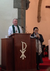 Bishop Alan preaching (with an interpreter) in Busan Cathedral during the WCC Assembly.