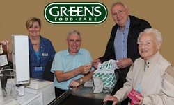 Rev Canon Sam Wright, under the watchful eye of staff member Maureen Wilson, is pictured serving customers Jack Hassard and Agnes Johnston in Greens Foodfare.
