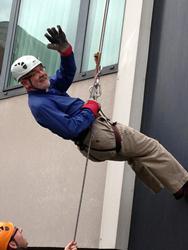 Barry Dodds abseils from the roof of the Europa Hotel.