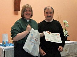 The Rev Arlene Moore, Priest in Charge of the Church of the Good Shepherd, with her certificate presented by tutor Niall Maclochlainn.