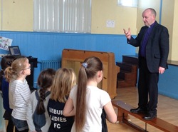 The Bishop speaks to schoolchilren during Holy Week.