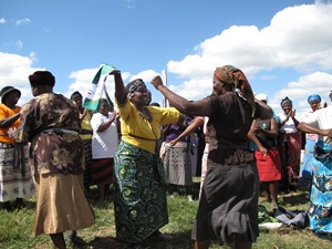 Ladies dancing joyously as they greet the Christian Aid group at one of the garden projects.