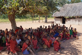 Pupils at Nzovunde School have some of their classes under a tree.