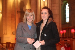 A represenative of the Northern Ireland Hospice is presented with a cheque by BBC journalist Tara Mills.