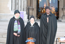 Dean Mann on the steps of St Anne's during the Black Santa sitout with the Rev Janice Elsdon and Canon Jerome Munyangaju.