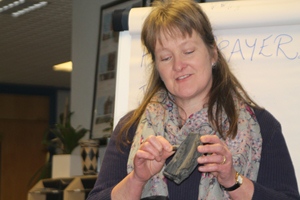 Jenny Smyth, CMSI, shows the bullet lodged in charcoal, a reminder of past conflicts in South Sudan, at the META meeting.