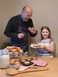 Roger Thompson, rector of St Patrick's with All Saints,'  enjoys sampling a cupcake baked by six-year-old Sophia Woods.