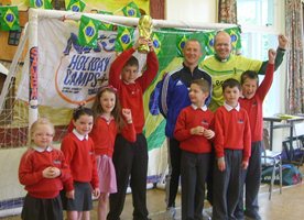 The Rev Roger Thompson and IFA development officer Wes Gregg with football fans at Cairncastle Primary School.