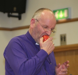 Bishop Alan illustrates his talk at Bushmills with an apple!