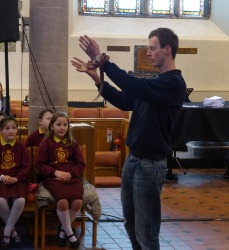 Gary from the pet shop introduces the visiting snake to dozens of enthralled schoolchildren in St Patrick's Church.