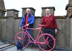 George and David secure the pink bike at the top of the St Cedma's tower.