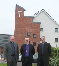 Rev David Boyland, rector; the Bishop of Connor, and diocesan Registrar the Rev Canon Willam Taggart outside St Hilda's new church.