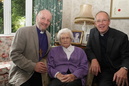 Mrs Mollie Holmes is congratulated on her 100th birthday by Bishop Alan Abernethy and the Rev Brian Howe.