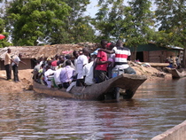 An overloaded canoe crosses the River Congo.