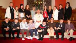 The Bishop of Connor, the Rt Rev Alan Harper, Rev Nicholas Dark - Rector of Magheragall Parish (left) and Jill Belshaw and Jacqui Adams - Peoples Warden (right) are pictured with fifteen candidates from Magheragall Parish Church who were confirmed on November 26.