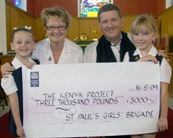 Treasurer Linda Dickey and girls from St Paul’s Girls’ Brigade present a £3,000 cheque for the St Paul’s Kenya Project to team leader, the Rev Jim Carson.