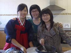 Three members of the Korean Christian Church help prepare the snack at Derryvolgie Parish.