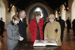 The Rev Edith Quirey, Martin McAleese, President Mary McAleese, and Agnes Young look through a book on the history of St Luke's during the President's visit.