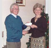 The Rev John Cunningham presents the cheque for £600 to Nessie Blair, chairperson of Breathe Easy Causeway. Photo: Ballymoney and Moyle Times.