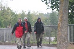 Wet? Archeacons Stephen Forde and Stephen McBride and Chancellor Stuart Lloyd stride out along Stranmillis Embankment.