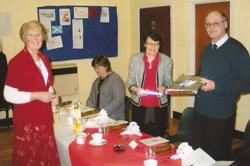 Hilary Moore, wife of Monday Club organiser John Moore, presents gifts from the Monday Club to Canon and Mrs Irwin.