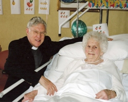 Dean John Bond congratulates Mrs Mary McCleary on her 100th birthday.