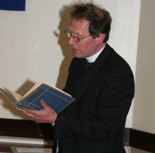 Pilgrimage leader Canon John Mann reading at a meeting of pilgrims last April.